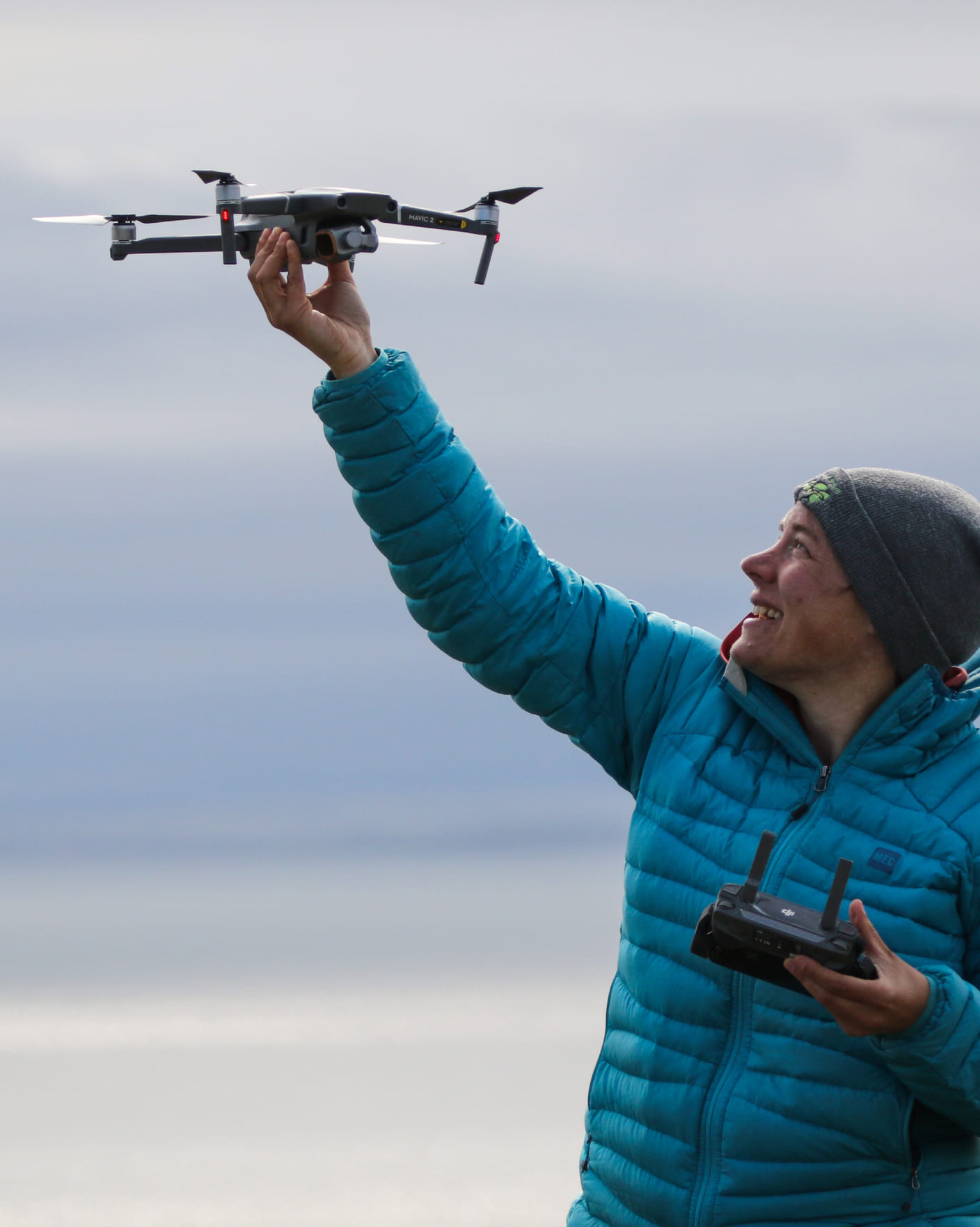 a woman holding a remote control airplane in her hand